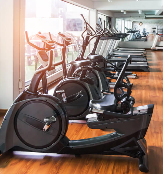 exercise bikes lined up in a gym